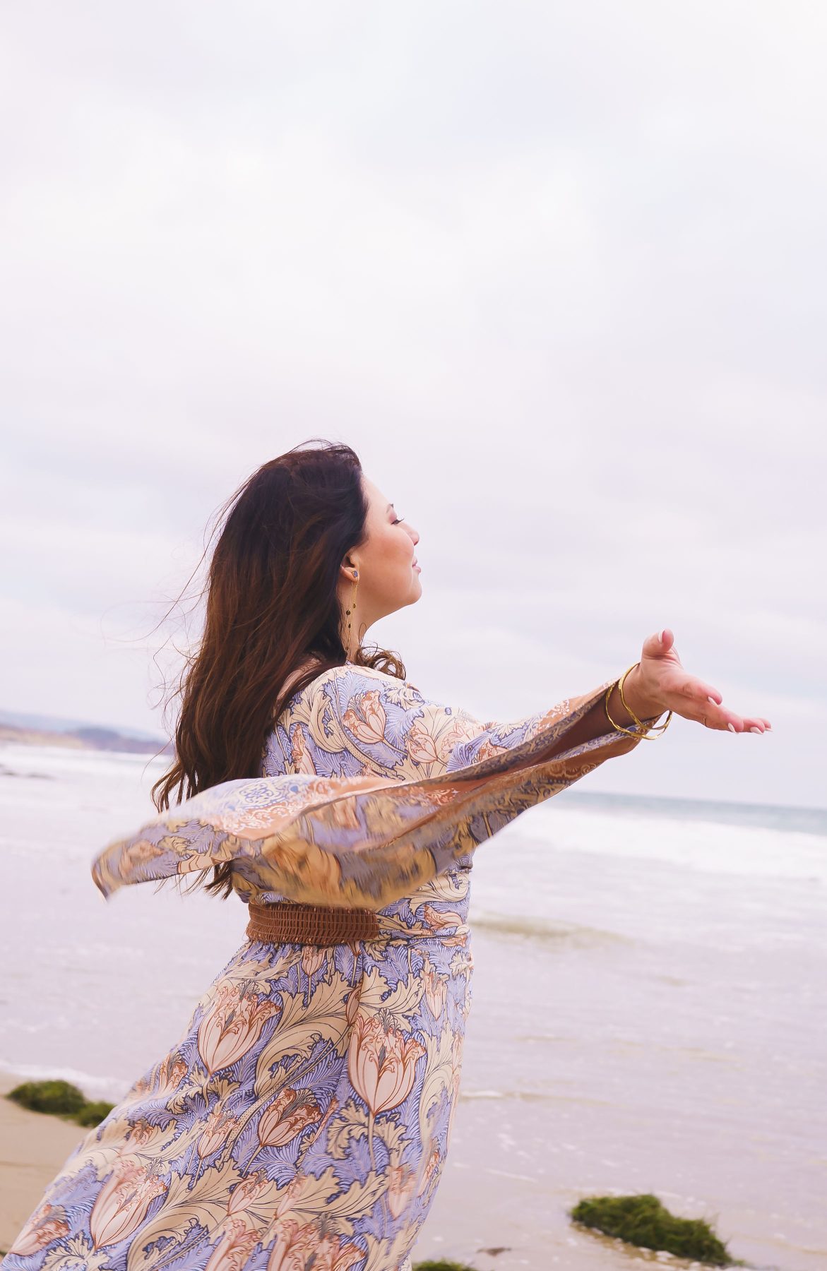 Desiree with arms open on the beach